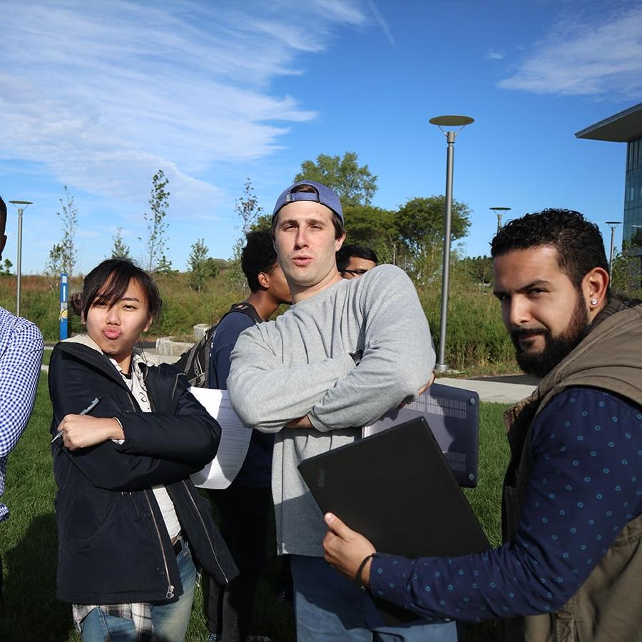 IT students pose on campus center lawn.